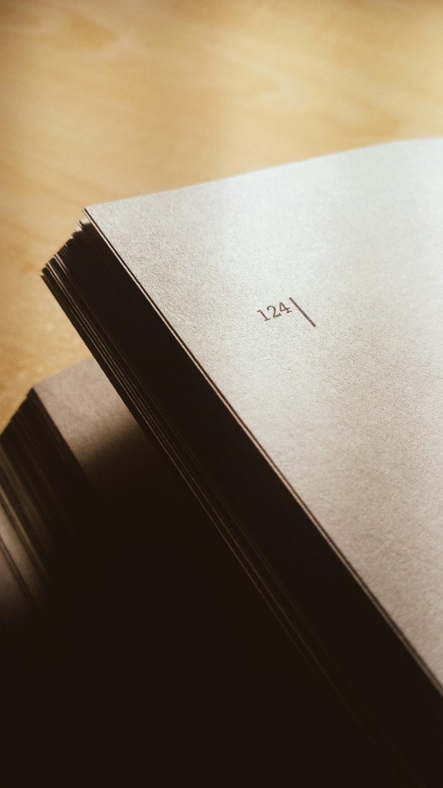 Close-up shot of open book displaying page number 124 on paper.
