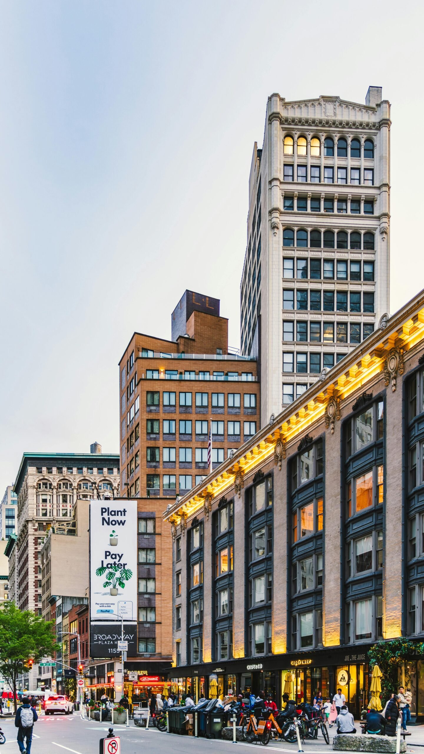 Dynamic NYC street scene showcasing modern skyscrapers and bustling urban life at twilight.